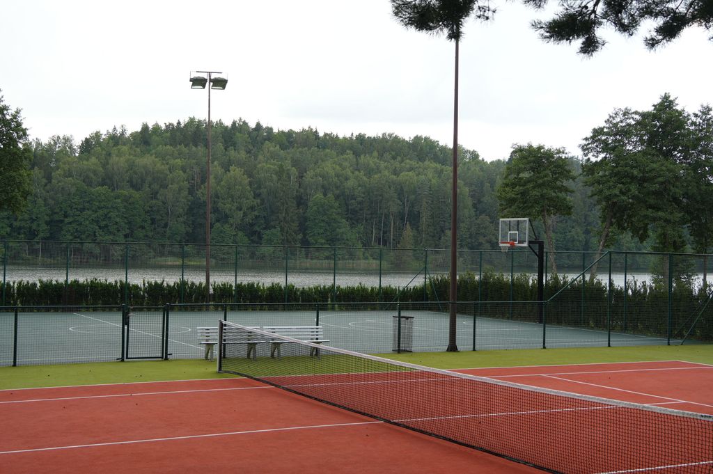 Tennis activities and lakeside wellness moments surrounded by serene nature.
