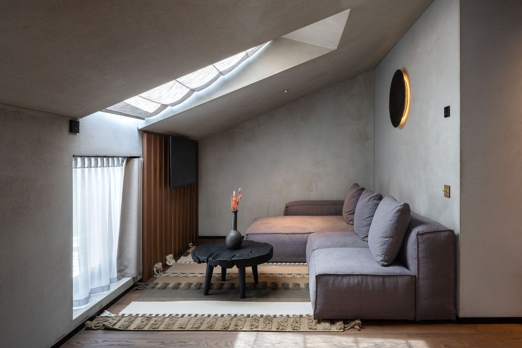 Minimalist loft suite interior featuring serene design with warm natural textures.