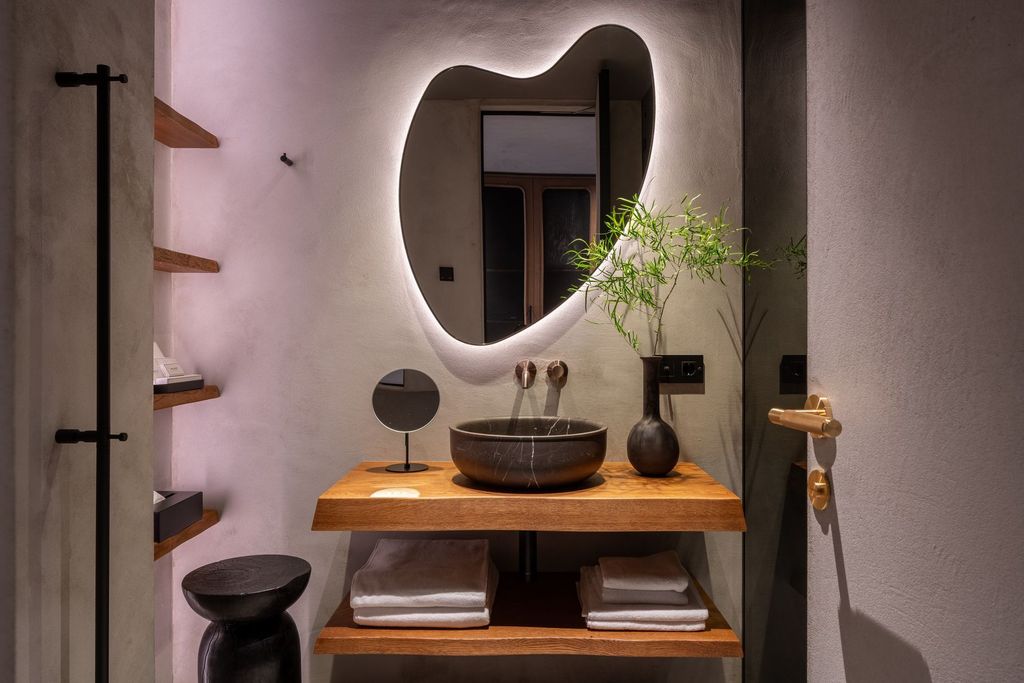 Elegant Loft Room bathroom displays wooden details and essential amenities.
