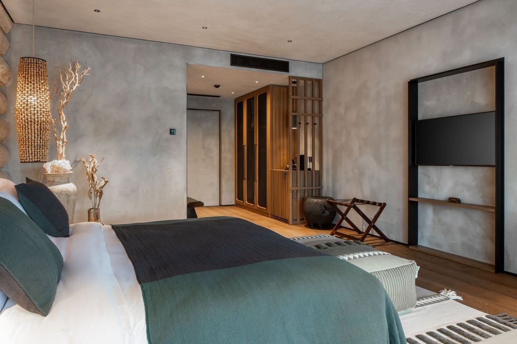 Signature lakefront room with king bed, terrace access, and panoramic lake views.