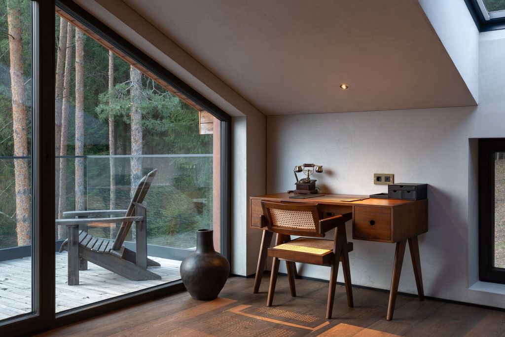 Minimalist loft room featuring stone and wood interiors with calming forest view.