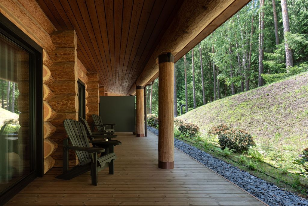Relaxing forest suite lounge area with seating, natural decor, and terrace forest access.