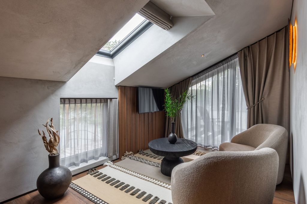 Loft Suite terrace with comfortable lounge seating and peaceful forest outlook.