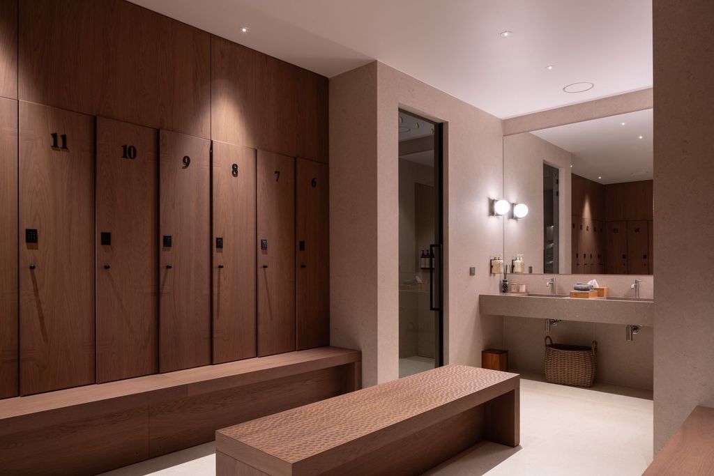 Spacious spa changing area with natural wood finishes and calming atmosphere..
