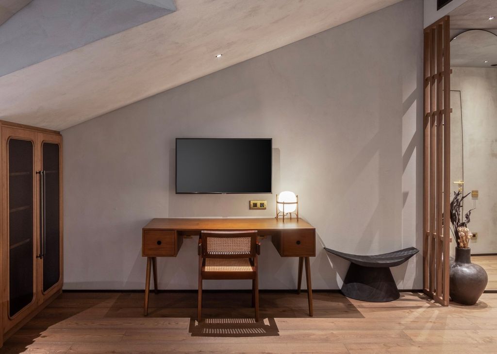 Loft room interior with wood-accent sitting area and TV for relaxing evenings.