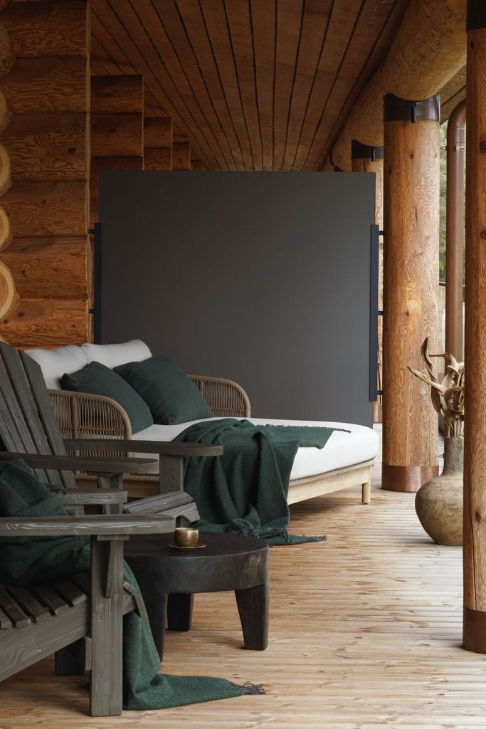 Cozy outdoor daybed with deep green cushions on a wooden terrace at Esperanza Lake Resort.